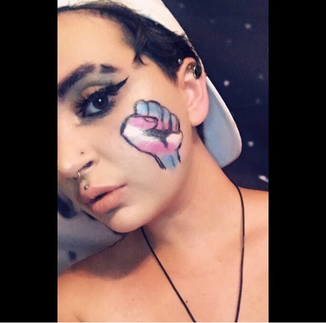 makeup look with a fist with the transgender colors