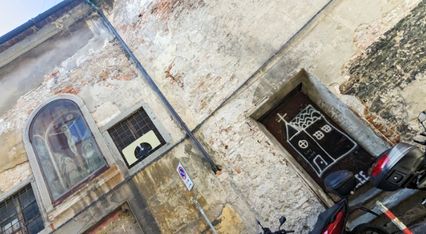 A crude spray painted drawing of a church with the words 'gay love'