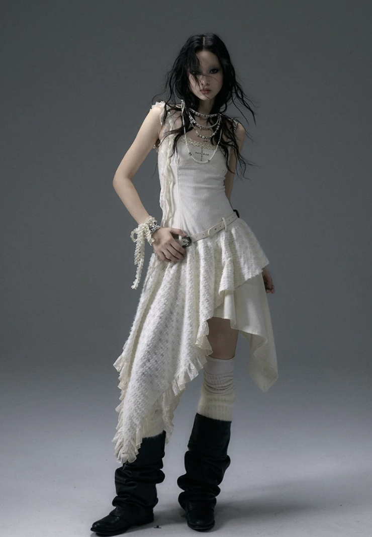 woman wearing a white/creme midi dress with knee high socks and black slouchy boots