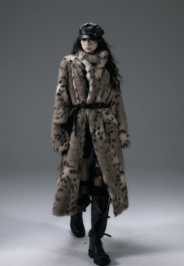 woman wearing a long, fluffy leopard print coat and leather boots