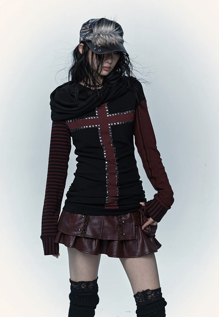 woman wearing a black and red long sleeve top with a cross on it