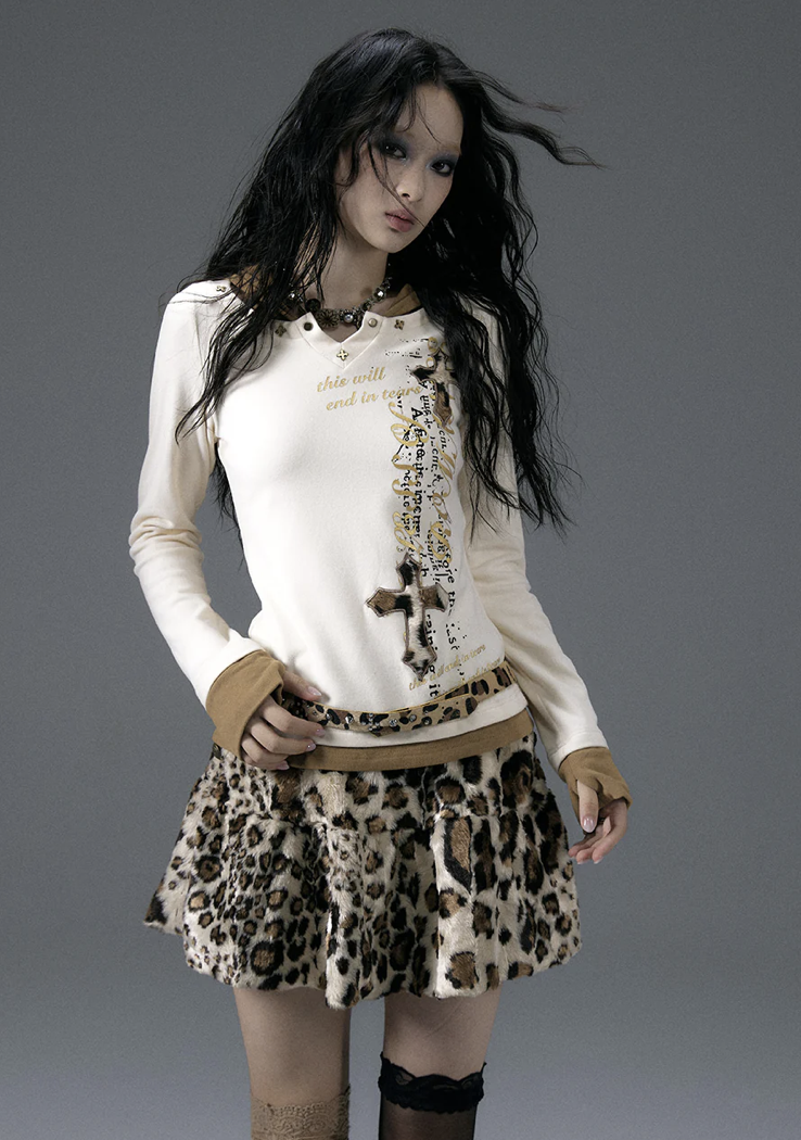 woman wearing cheetah print skirt and long sleeve graphic top