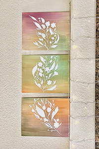 Three-canvas painting depicting a floral stem