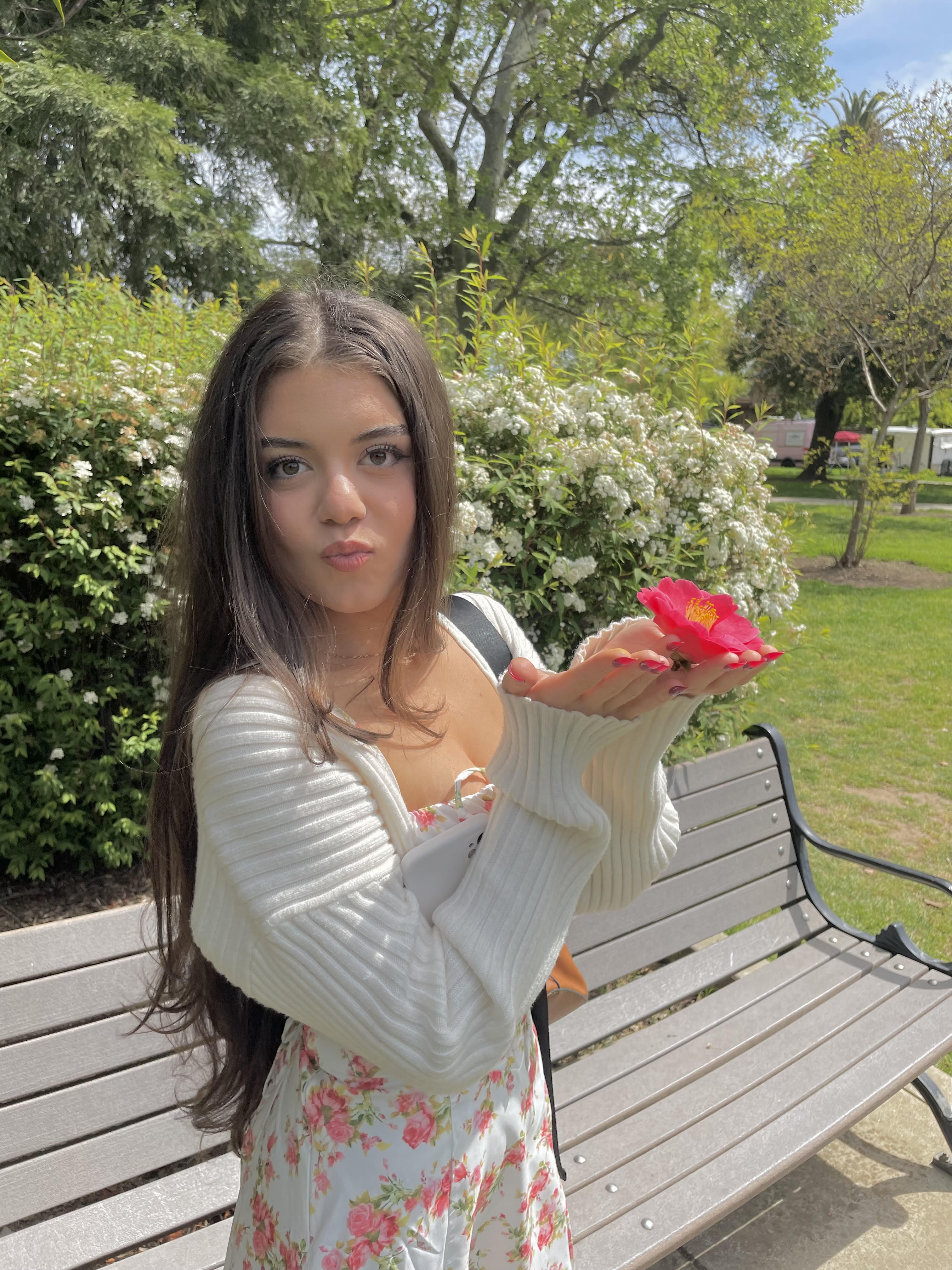 marina holding a flower in her hands
