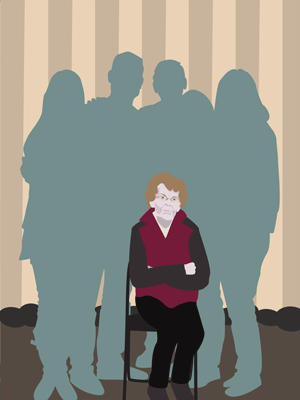 Senior woman sitting down surrounded by adult family members.