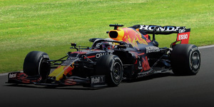 Photo of Red Bull Driver Max Verstappen in his car racing on the track