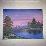 This picture is of an art piece that illustartes a forest like area with a lake. 