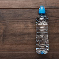 water bottle, wood backdrop, hydrate, skin hydration