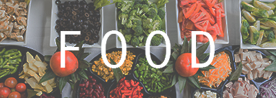 Vegetables laid out on table with white letters saying food