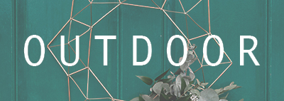 Blue door with hanging decor with white letters saying outdoor