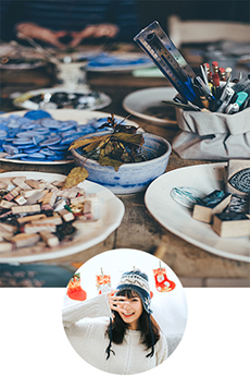 crafts behind girl smiling in beanie