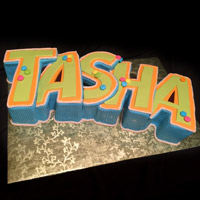A cake in the shape of the name Tasha. Click here for a larger picture.
