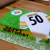 A cake that looks like a sport's jursey on turf with the Stealers logo. Click here for a larger picture.