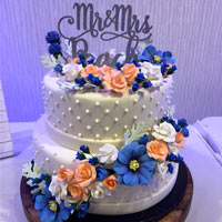 A double-layer cake with flowers trailing down. 'Mr & Mrs Peach' cake topper. Click here for a larger picture.