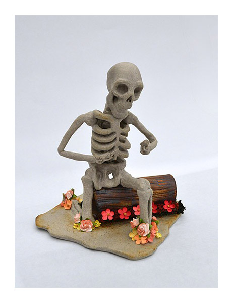 Clay, skeleton sitting on log