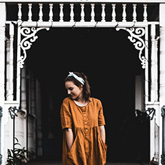 moody portrait with white house as frame