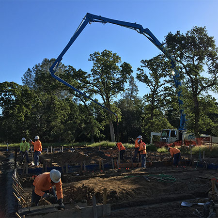 an image of the CVC pour crew, pouring a the footings for a two-pour slab in Rocklin. This was a out of level custom home job.