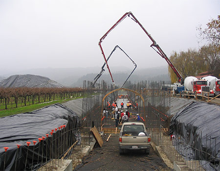 There is a concrete pour crew pouring stem walls for the Del Dado Winery