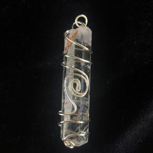 Clear quartz pendant wrapped in silver wire.