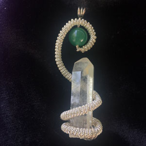 Quartz point and adventurine pendant wrapped in a silver wire coil.