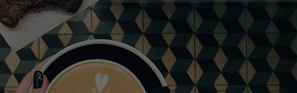 coffee held over tile floor