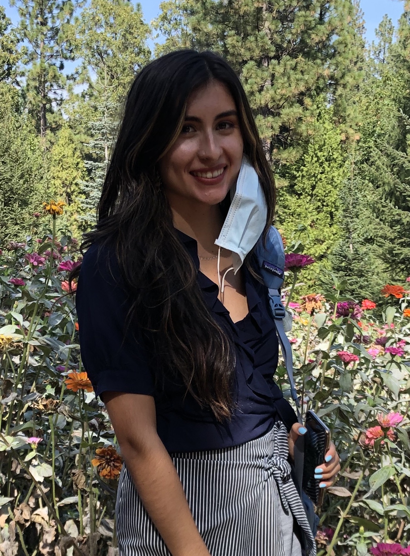 girl smiling by flowers