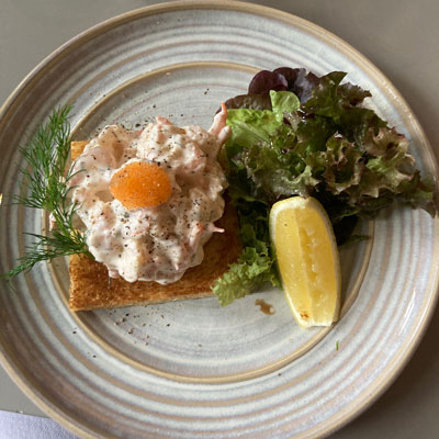 Toast skagen on a plate with lemon