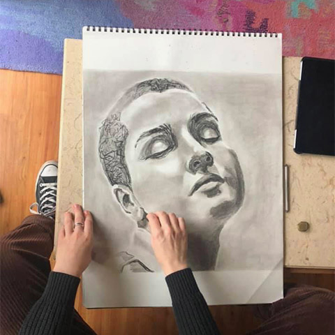 Birds eye view of Hanna drawing self portrait