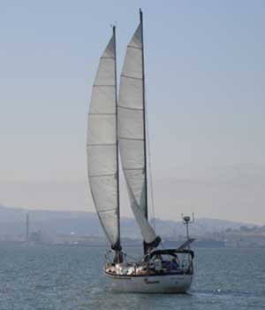 image of the Toucan under full sail from behind