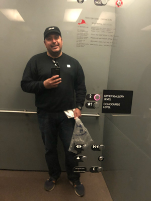 Moises Castillo dressed in black inside elavator