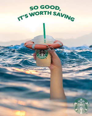 A starbucks advertisment with a hand holding a cup out of water