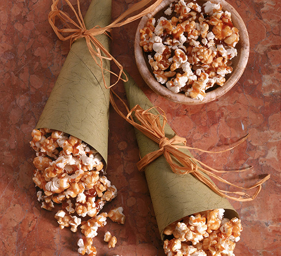 Caramel Popcorn decorated on a table in a bowl and wrapped up.