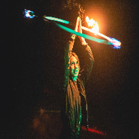 Women playing with a hulahoop that is on fire