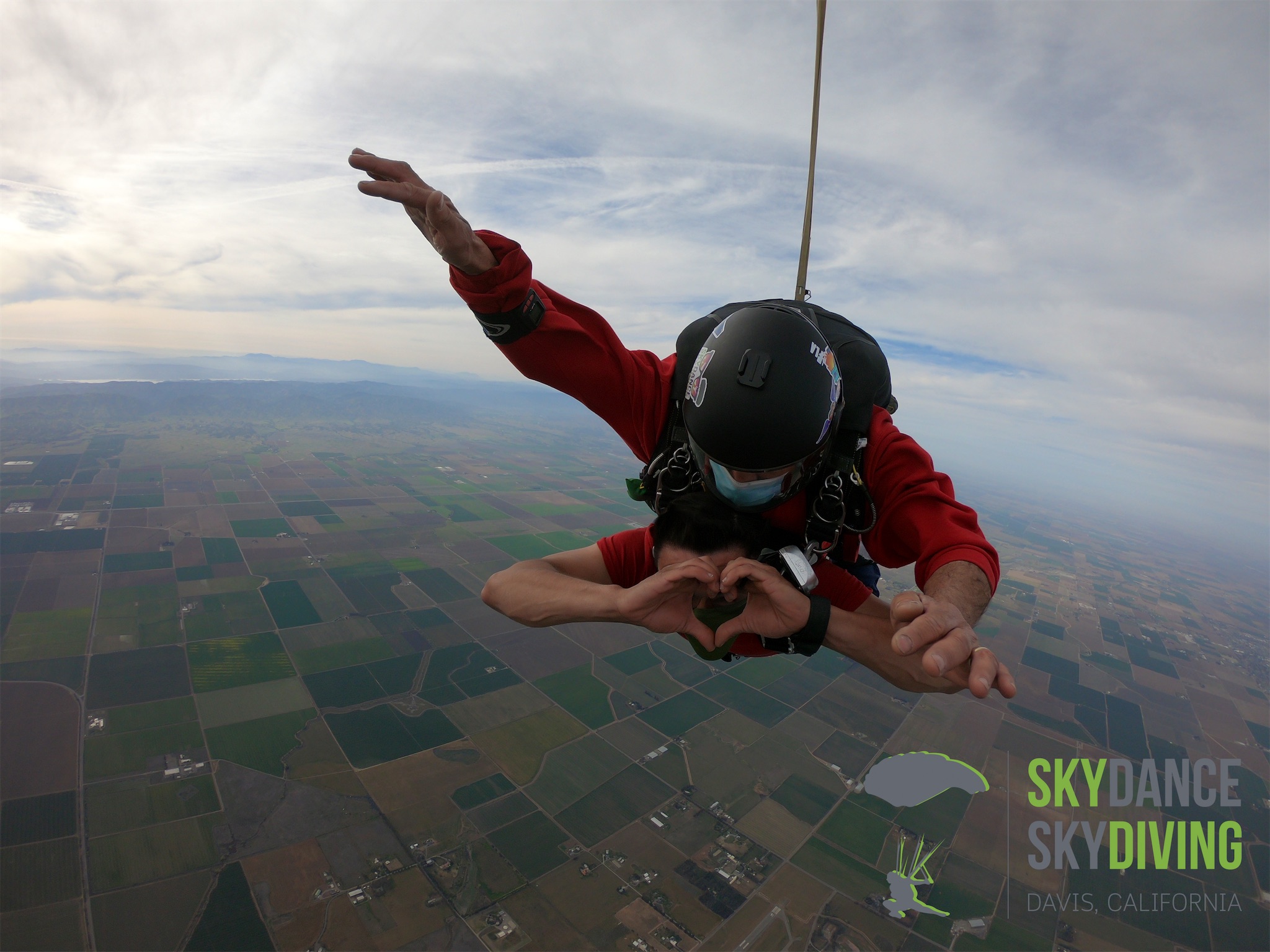 Picture of me making a heart shape with my hands as I fall from the sky