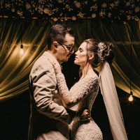 A newly married couple dances close in the evening