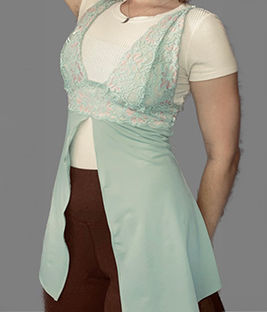 A model wearing the same light blue tank top and the top now has a slit up the middle of the stomach