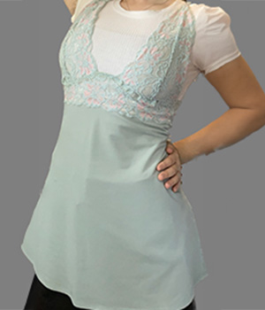 A model weaing a light blue tank top with a lacey design at the top