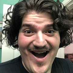 A casual photo of Daniel Vela, his mouth agape, making a funny face.