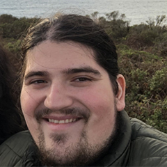 A professional photo taken of the artist Daniel Vela by the California Coastline.