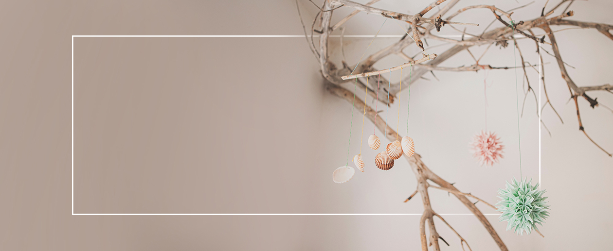 A branch with decorations hangin on it.