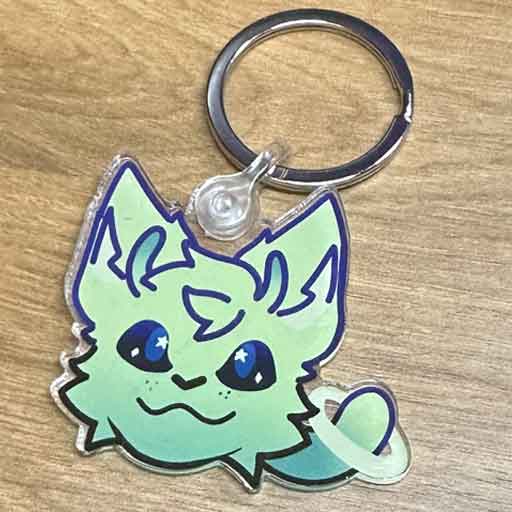 Acrylic key chain with a drawing of a green space cat