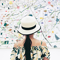 image of a women staring at an art piece on the wall