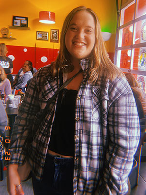 Image of Jordann Klein standing in a resturant with a color filter applied to the image
