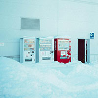Three vending machines covered in snow