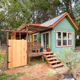 House featuring a constructed deck and door