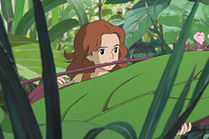 a tiny young girl crawling through the leaves