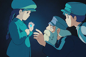 a young boy and girl with an older man pointing to her shiny necklace