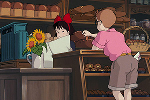 a young boy talking to a young girl at a bakery counter