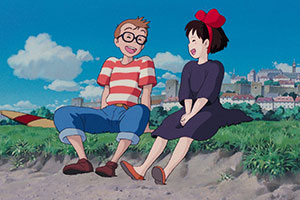 a young girl and boy laughing on the beach