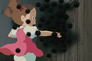 a young girl and tiny lively soot sprite beings